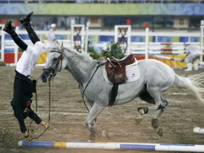Cao Zhongrong of China falls from his horse ChuChu during the men's riding show jumping event of the modern pentathlon competition at the Beijing 2008 Olympic Games, August 21, 2008.   REUTERS/Claro Cortes IV (CHINA)