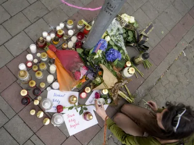 13 October 2022, Slovakia, Bratislava: People put down candles at the scene of a shooting outside a gay bar. A man in Bratislava killed two men and seriously injured a waitress near a popular gay pub in the city centre on Wednesday evening. Photo: Pavol Zachar/TASR/dpa