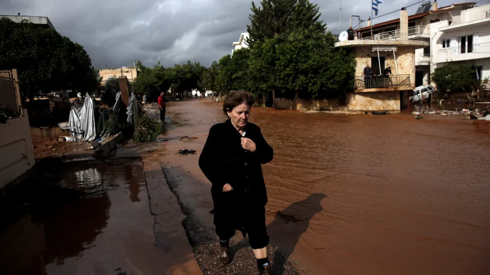 ﻿A local walks next to a flooded street following a heavy rainfall in the town of Mandra, Greece, November 15, 2017. REUTERS/Alkis Konstantinidis