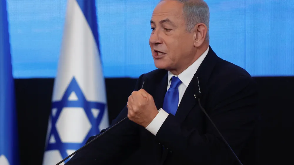 Likud party leader Benjamin Netanyahu gestures as he addresses his supporters at his party headquarters during Israel's general election in Jerusalem, November 2, 2022. REUTERS/Ammar Awad
