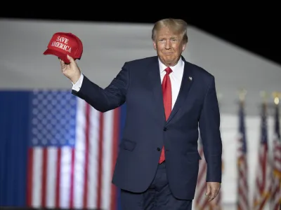 FILE - Former President Donald Trump makes his entrance at a rally at the Minden Tahoe Airport in Minden, Nev., Oct. 8, 2022. (AP Photo/Jos&eacute; Luis Villegas, File)