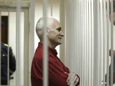 FILE- Ales Belyatsky, the jailed leader of Vesna, the most prominent human rights group in Belarus, stands in a cage during a court session in Minsk, Belarus, Thursday, Nov. 24, 2011. Ales Belyatsky won the Nobel Peace Prize Friday, Oct. 7, 2022. (AP Photo/Sergei Grits, FILE)