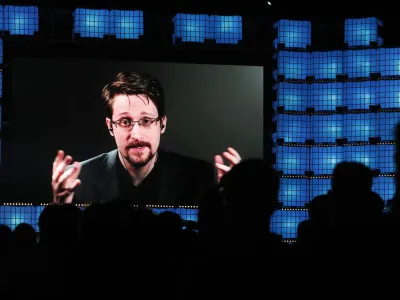 FILE - Former U.S. National Security Agency contractor Edward Snowden addresses attendees through video link at the Web Summit technology conference in Lisbon on Nov. 4, 2019. Snowden, who fled prosecution after he revealed highly classified U.S. surveillance programs, has received a Russian passport and taken the citizenship oath, his lawyer was quoted by Russian news agencies as saying Friday Dec. 2, 2022. (AP Photo/Armando Franca, File)