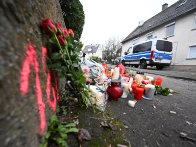 06 December 2022, Baden-Wuerttemberg, Illerkirchberg: Candles and flowers can be seen at a crime scene where two girls were attacked and seriously injured on their way to school by a man with a knife. Photo: Bernd Wei&szlig;brod/dpa
