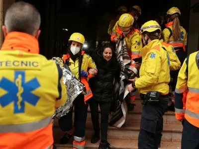 A wounded person is helped by medical emergency after two trains collided in Spain's northeastern Catalonia region, in Montcada i Reixac, near Barcelona, Spain December 7, 2022. REUTERS/Nacho Doce
