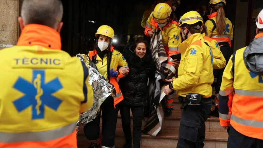 A wounded person is helped by medical emergency after two trains collided in Spain's northeastern Catalonia region, in Montcada i Reixac, near Barcelona, Spain December 7, 2022. REUTERS/Nacho Doce