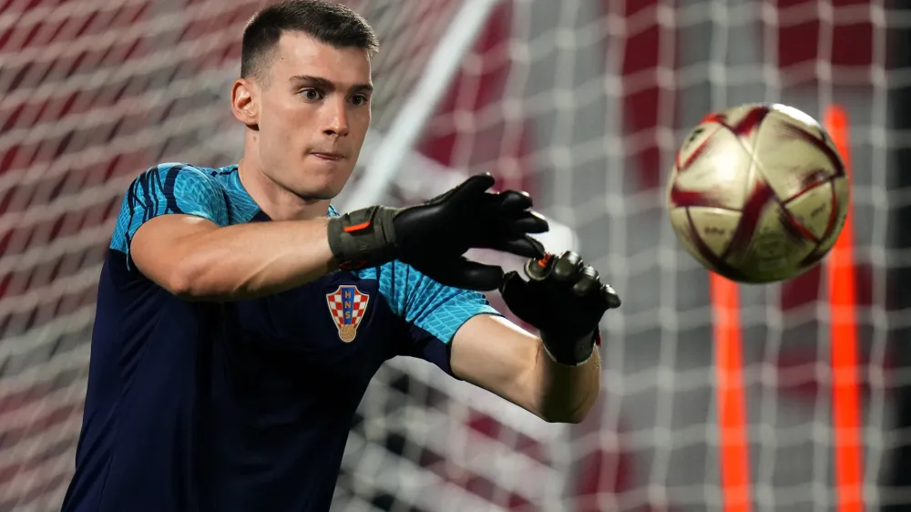 Croatia's goalkeeper Dominik Livakovic catches the ball during the training session on the eve of the 2022 World Cup semifinal soccer match between Croatia and Argentina in Doha, Monday, Dec. 12, 2022. (AP Photo/Petr David Josek)