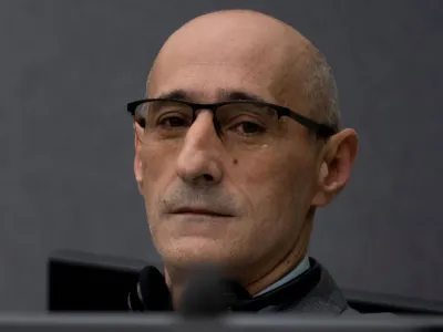 Salih Mustafa, a former Kosovo rebel, waits in the Kosovo Specialist Chambers court for the judges to read the verdict in The Hague, Netherlands, December 16, 2022. Mustafa is charged with the war crimes of arbitrary detention, cruel treatment, the torture of at least six people and the murder of one person at a detention compound in Zllash, Kosovo, in April 1999. Salih Mustafa pleaded not guilty to all charges. Peter Dejong/Pool via REUTERS