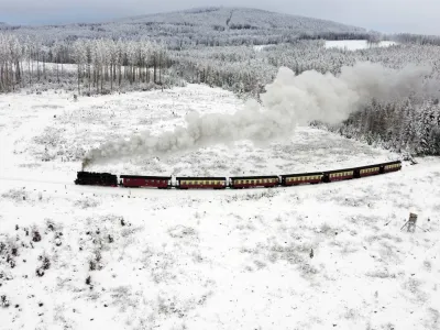 A steam train drives through a snow-covered landscape at the Harz mountains near Wernigerode, Germany, Friday, Dec. 9, 2022. (AP Photo/Matthias Schrader)