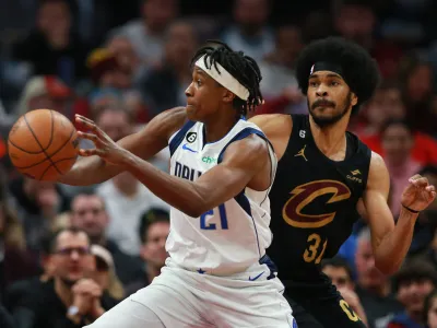 Dec 17, 2022; Cleveland, Ohio, USA; Dallas Mavericks guard Frank Ntilikina (21) passes the ball against Cleveland Cavaliers center Jarrett Allen (31) in the second half at Rocket Mortgage FieldHouse. Mandatory Credit: Aaron Josefczyk-USA TODAY Sports