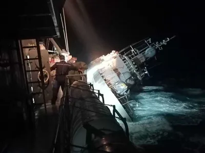In this photo provided by the Royal Thai Navy, the HTMS Sukhothai corvette warship lists off the coast of Prachuap Khiri Khan province, Thailand, Sunday, Dec. 18, 2022. The Thai navy ship sunk in the Gulf of Thailand and ships and helicopters were working Monday to rescue sailors from the water. (Royal Thai Navy via AP)