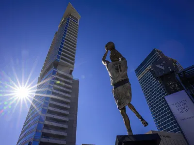 Dec 25, 2022; Dallas, Texas, USA; A general view of the Dallas city skyline and the statue by sculptor Omri Amrany honoring former Dallas Mavericks power forward Dirk Nowitzki before the game between the Dallas Mavericks and the Los Angeles Lakers American Airlines Center. Mandatory Credit: Jerome Miron-USA TODAY Sports