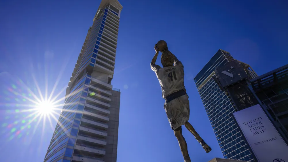 Dec 25, 2022; Dallas, Texas, USA; A general view of the Dallas city skyline and the statue by sculptor Omri Amrany honoring former Dallas Mavericks power forward Dirk Nowitzki before the game between the Dallas Mavericks and the Los Angeles Lakers American Airlines Center. Mandatory Credit: Jerome Miron-USA TODAY Sports