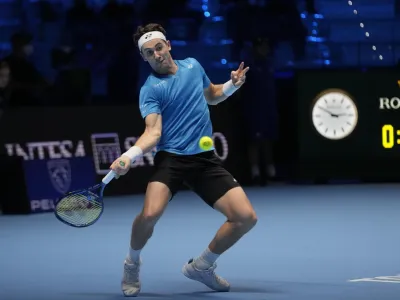 ﻿Norways' Casper Ruud returns the ball to Russia's Andrey Rublev during their ATP World Tour Finals singles tennis match, at the Pala Alpitour in Turin, Friday, Nov. 19, 2021. (AP Photo/Luca Bruno)