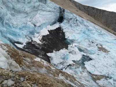 This undated image made available Monday, July 4, 2022, by the press office of the Autonomous Province of Trento shows the glacier in the Marmolada range of Italy's Alps near Trento from which a large chunk has broken loose Sunday, killing at least six hikers and injuring eight others. Drones were being used to spot any more bodies on an Italian Alpine mountainside a day after a huge chunk of a glacier broke loose, sending an avalanche of ice, snow, and rocks onto hikers. Rescuers on Sunday spotted six bodies and said nine survivors were injured. Attention on Monday was focused on determining how many people who might have been hiking on the Marmolada peak are unaccounted for. Rescuers said conditions downslope from the glacier, which has been melting for decades, were still too unstable to immediately send rescuers and dogs into the area to look for others buried under tons of debris. (Autonomous Province of Trento via AP)