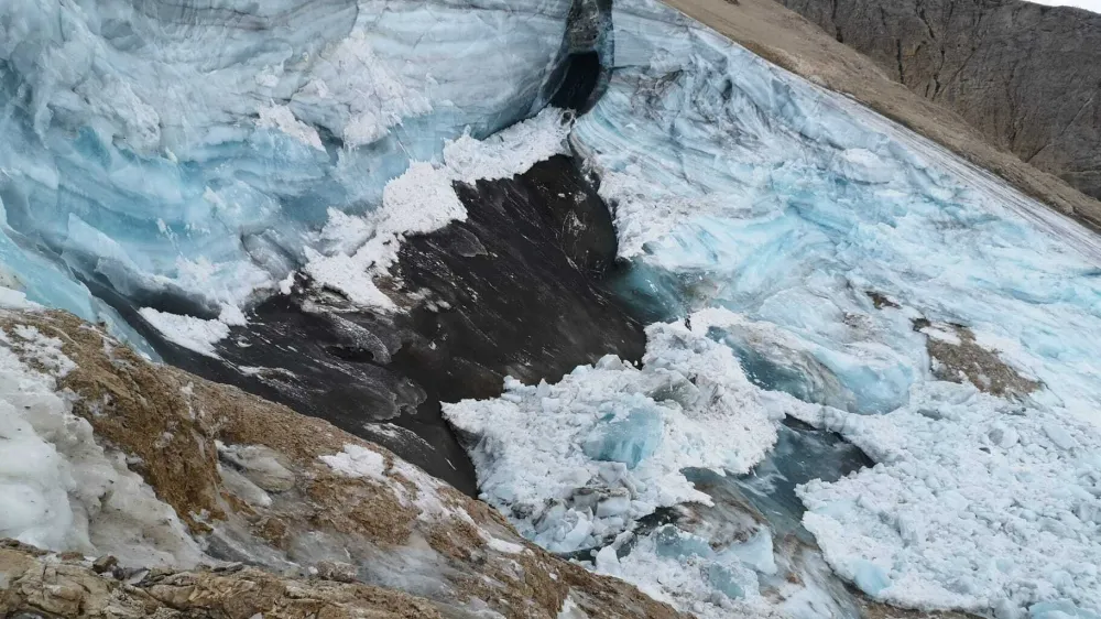 This undated image made available Monday, July 4, 2022, by the press office of the Autonomous Province of Trento shows the glacier in the Marmolada range of Italy's Alps near Trento from which a large chunk has broken loose Sunday, killing at least six hikers and injuring eight others. Drones were being used to spot any more bodies on an Italian Alpine mountainside a day after a huge chunk of a glacier broke loose, sending an avalanche of ice, snow, and rocks onto hikers. Rescuers on Sunday spotted six bodies and said nine survivors were injured. Attention on Monday was focused on determining how many people who might have been hiking on the Marmolada peak are unaccounted for. Rescuers said conditions downslope from the glacier, which has been melting for decades, were still too unstable to immediately send rescuers and dogs into the area to look for others buried under tons of debris. (Autonomous Province of Trento via AP)