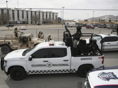 Mexican National Guard stand guard outside a state prison in Ciudad Juarez, Mexico, Sunday Jan 1, 2023. Mexican soldiers and state police regained control of a state prison in Ciudad Juarez across the border from El Paso, Texas after violence broke out early Sunday, according to state officials. (AP Photo/Christian Chavez)