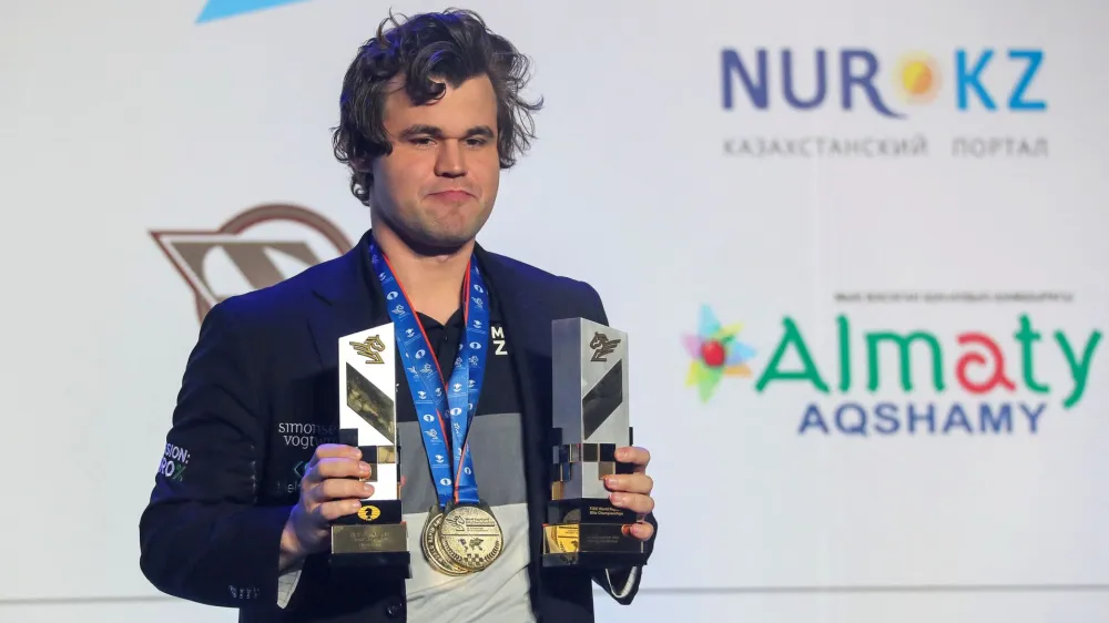 Chess - FIDE World Rapid and Blitz Championships 2022 - Award Ceremony - Almaty, Kazakhstan - December 30, 2022. World Rapid and Blitz Champion Magnus Carlsen of Norway holds his trophies. REUTERS/Pavel Mikheyev