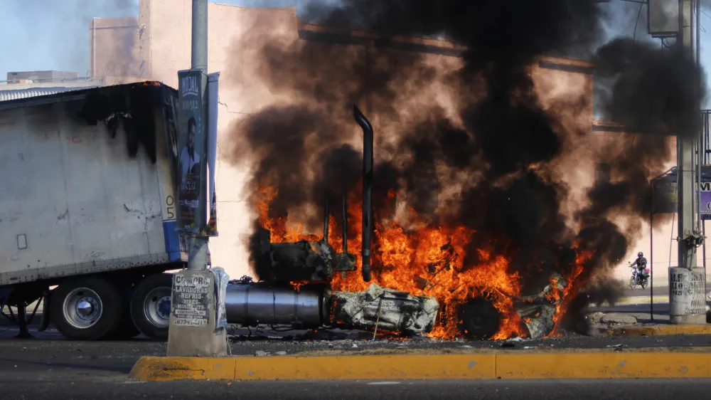 A truck burns on a street in Culiacan, Sinaloa state, Thursday Jan. 5, 2023. Mexican security forces captured Ovidio Guzmán, an alleged drug trafficker wanted by the United States and one of the sons of former Sinaloa cartel boss Joaquín "El Chapo" Guzmán, in a pre-dawn operation Thursday that set off gunfights and roadblocks across the western state's capital. (AP Photo/Martin Urista)
