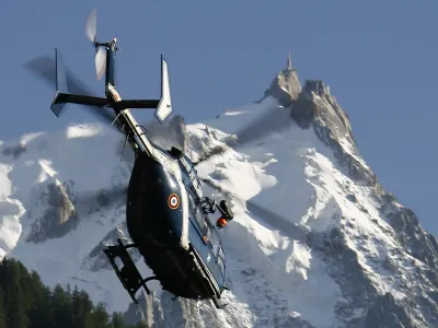 REFILE- CORRECTING YEAR<br><br>A French Gendarmerie rescue helicopter passes in front of the Aiguille du Midi as it takes off near Chamonix during search and rescue operations August 24, 2008. An avalanche hit climbers on Mont Blanc early August 24, injuring eight and leaving about ten others missing, according to the local rescue officials. REUTERS/Christian Hartmann (FRANCE)