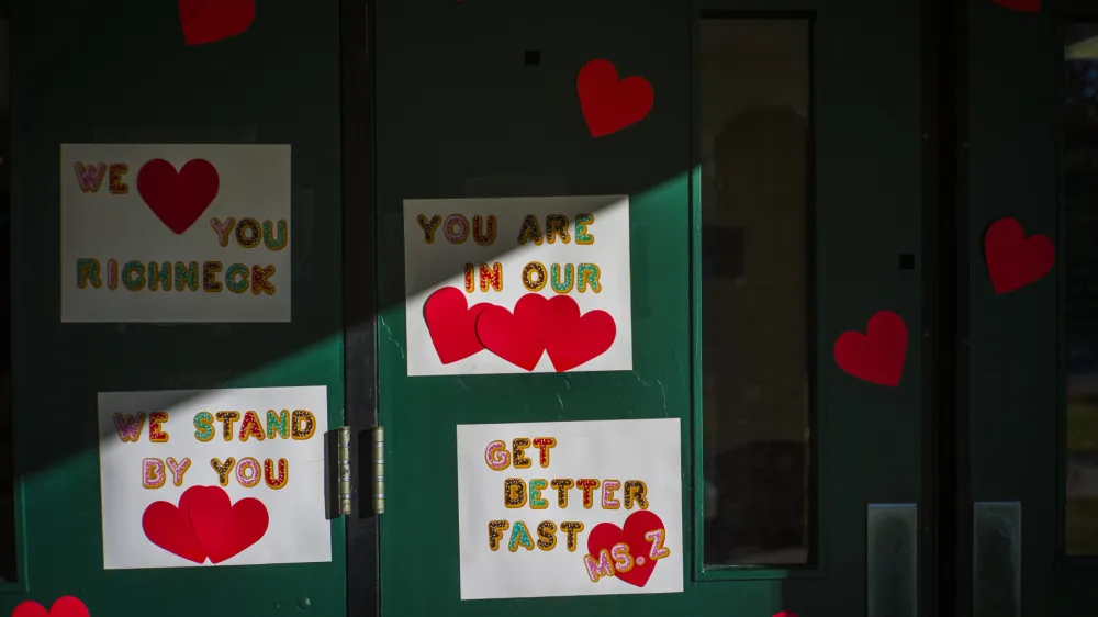 Messages of support for teacher Abby Zwerner, who was shot by a 6 year old student, grace the front door of Richneck Elementary School Newport News, Va. on Monday Jan. 9, 2023. The Virginia teacher who authorities say was shot by a 6-year-old student is known as a hard-working educator who's devoted to her students and enthusiastic about the profession that runs in her family. (AP Photo/John C. Clark)