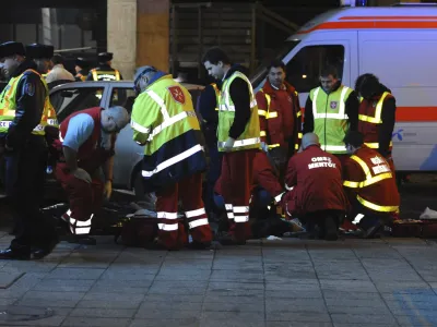 Ambulance personnel and police work outside West Balkan night club in Budapest, Hungary, Sunday, Jan. 16, 2011, in the early hours, after three girls died in a stampede. Budapest police spokeswoman Katalin Fanni Horvath says panic caused thousands of people to be caught up in the stampede and the victims may have been trampled by the rushing crowd. (AP Photo/MTI, Peter Lakatos)