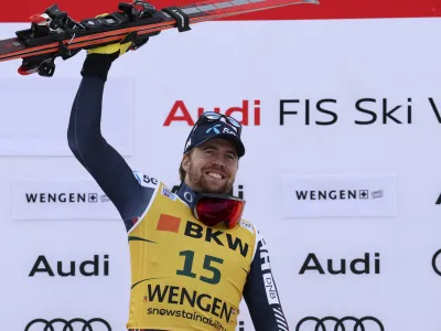 Norway's Aleksander Aamodt Kilde celebrates on the podium after winning an alpine ski, men's World Cup super G race, in Wengen, Switzerland, Friday, Jan. 13, 2023. (AP Photo/Alessandro Trovati)