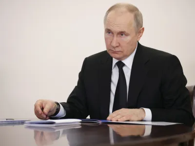 Russian President Vladimir Putin speaks to head of Bashkortostan Radiy Khabirov during their meeting in Ufa, the capital of Bashkortostan, Russia, Friday, Jan. 13, 2023. (Sergei Bobylev, Sputnik, Kremlin Pool Photo via AP)