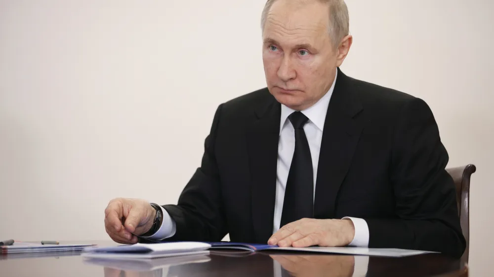 Russian President Vladimir Putin speaks to head of Bashkortostan Radiy Khabirov during their meeting in Ufa, the capital of Bashkortostan, Russia, Friday, Jan. 13, 2023. (Sergei Bobylev, Sputnik, Kremlin Pool Photo via AP)