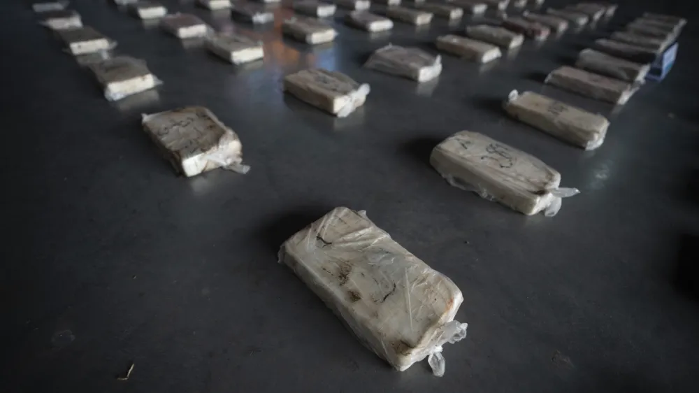 Confiscated cocaine is shown to the press at a police hangar in Buenos Aires, Argentina, Thursday, Oct. 6, 2022. Police say they arrested three men from Peru and three from Paraguay with almost half a ton of pure cocaine brought by land from Peru that was going to be cut and distributed in Buenos Aires. (AP Photo/Victor R. Caivano)