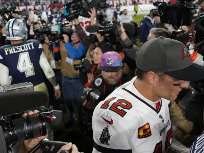 Tampa Bay Buccaneers quarterback Tom Brady (12) leaves the field after speaking with Dallas Cowboys quarterback Dak Prescott (4) after an NFL wild-card football game, Monday, Jan. 16, 2023, in Tampa, Fla. The Dallas Cowboys won 31-14. (AP Photo/Chris Carlson)