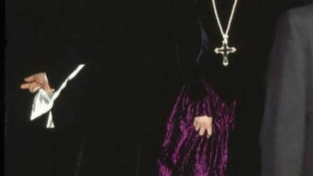 Diana, Princess Of Wales, arrives at a charity gala wearing a gold and amethyst crucifix in 1987