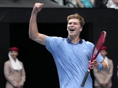 Jenson Brooksby of the U.S. celebrates after defeating Casper Ruud of Norway in their second round match at the Australian Open tennis championship in Melbourne, Australia, Thursday, Jan. 19, 2023. (AP Photo/Dita Alangkara)
