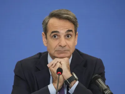 Greek Prime Minister Kyriakos Mitsotakis listens a question during a news conference, in Athens, Monday, Jan. 23, 2023. Mitsotakis voiced optimism that Greek government bonds can regain investment grade within 2023, which would ease the country's borrowing costs. (AP Photo/Petros Giannakouris)
