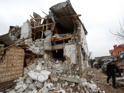 A local resident carry home staff from a house of his neighbour damaged by a Russian military strike, amid Russia's attack on Ukraine, in the town of Hlevakha, outside Kyiv, Ukraine January 26, 2023. REUTERS/Valentyn Ogirenko