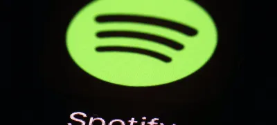 FILE- This March 20, 2018 file photo shows the Spotify app on an iPad in Baltimore. Music streaming service Spotify says it's cutting 6% of its workforce, becoming yet another tech company resorting to layoffs as the economic outlook worsens. CEO Daniel Ek announced the restructuring in a message to employees that was also posted online Monday, Jan. 23, 2023. (AP Photo/Patrick Semansky, File)