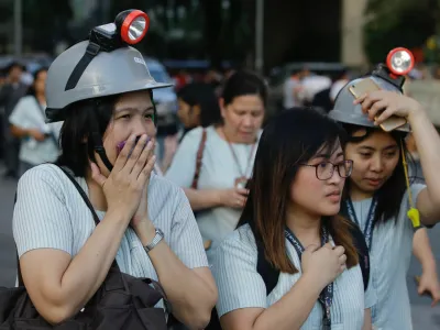 ﻿Wearing protective helmets, employees evacuate their office building following an earthquake in Manila, Philippines Monday, April 22, 2019. A strong earthquake has shaken the area around the Philippine capital, prompting thousands of people to flee to safety. There were no immediate reports of injuries or widespread damage. The U.S. Geological Survey says the magnitude 6.3 quake struck northwest of Manila near the town of Gutad on Luzon island. (AP Photo/Aaron Favila)