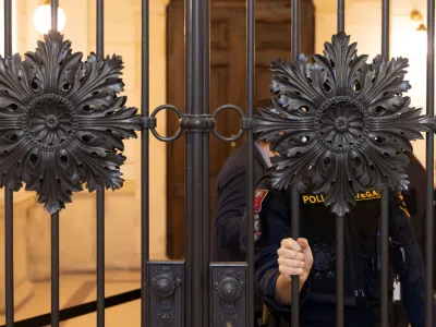 An Austrian police officer waits outside the courtroom as the verdict for six men accused of providing various degrees of help to a jihadist who killed four people in a shooting rampage in Vienna in November 2020 is expected, in Vienna, Austria, February 1, 2023. REUTERS/Lisa Leutner