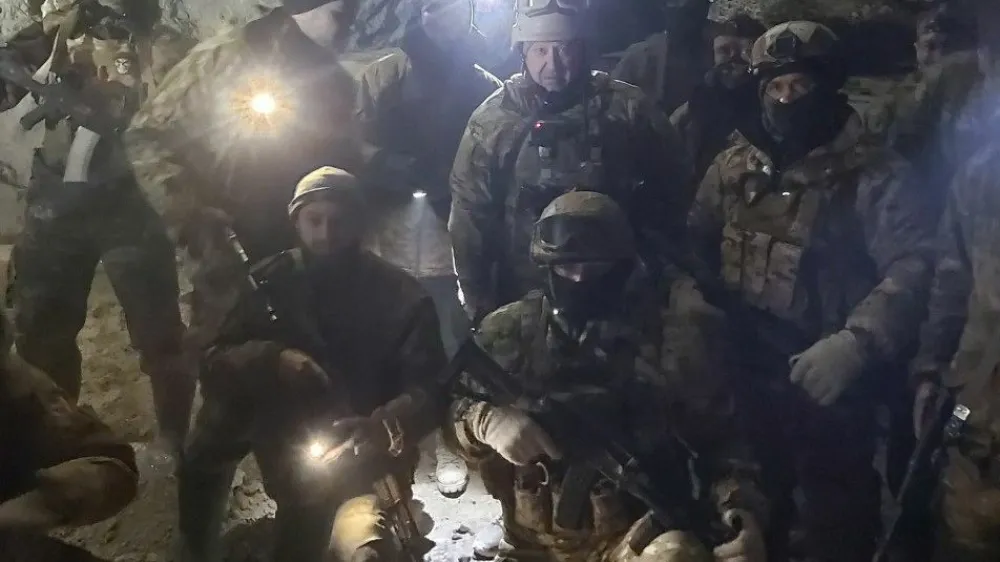 People in military uniform, claimed to be soldiers of Russian mercenary group Wagner and its head Yevgeny Prigozhin, pose for a picture believed to be in a salt mine in Soledar in the Donetsk region, Ukraine, in this handout picture released January 10, 2023. Press service of "Concord"/Handout via REUTERS ATTENTION EDITORS - THIS IMAGE WAS PROVIDED BY A THIRD PARTY. NO RESALES. NO ARCHIVES. MANDATORY CREDIT.