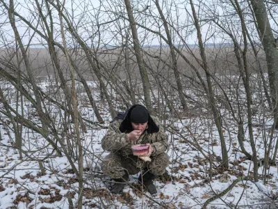 A Ukrainian army soldier from the 43rd Heavy Artillery Brigade eats, amid Russia's attack on Ukraine, near Bahmut, in Donetsk region, Ukraine, February 5, 2023. REUTERS/Marko Djurica   TPX IMAGES OF THE DAY
