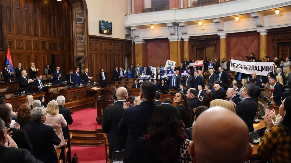 Lawmakers hold pictures of assassinated Kosovo Serb politician Oliver Ivanovic and banners that read: "Not to the ultimatum!" and "Vucic, betrayed Kosovo", during a special session of Serbia's parliament about the negotiating process with Kosovo in Belgrade, Serbia, February 2, 2023. REUTERS/Zorana Jevtic.