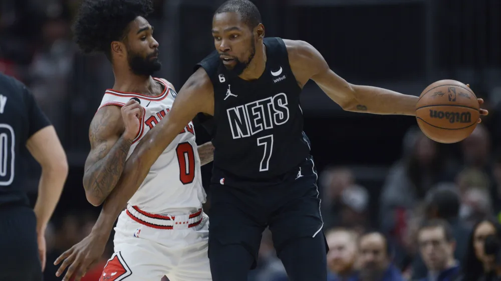 FILE - Brooklyn Nets' Kevin Durant (7) looks to drive against Chicago Bulls' Coby White (0) during the second half of an NBA basketball game Wednesday, Jan. 4, 2023, in Chicago. Chicago won 121-112. The Phoenix Suns pulled a midnight blockbuster on Wednesday, Feb. 9, 2023, acquiring 13-time All-Star Durant from the Brooklyn Nets, according to multiple reports. (AP Photo/Paul Beaty, File)