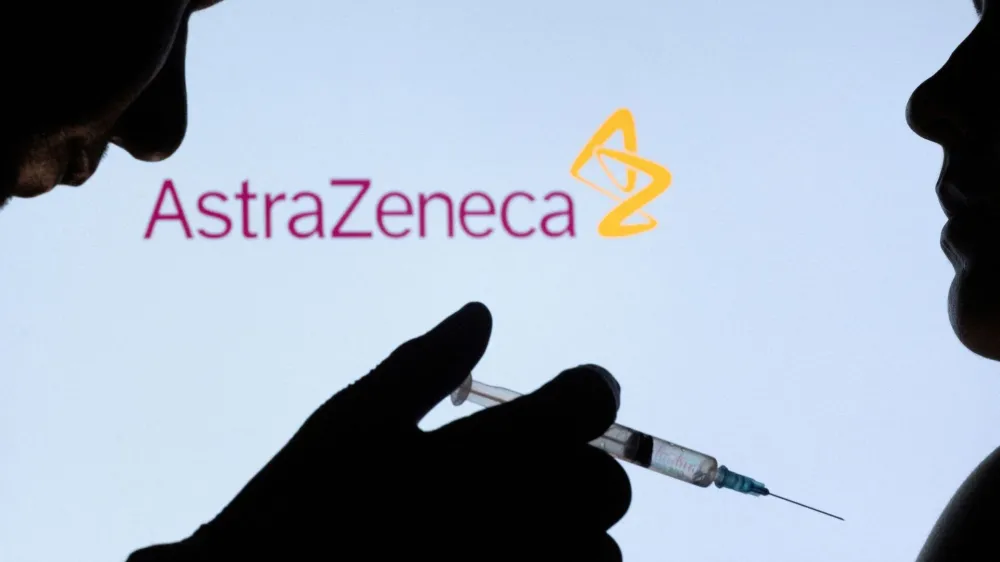 FILE PHOTO: People pose with syringe with needle in front of displayed AstraZeneca logo in this illustration taken, December 11, 2021. REUTERS/Dado Ruvic/Illustration/File Photo