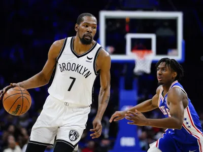 ﻿Brooklyn Nets' Kevin Durant, left, dribbles past Philadelphia 76ers' Tyrese Maxey during the second half of an NBA basketball game, Thursday, March 10, 2022, in Philadelphia. (AP Photo/Matt Slocum)