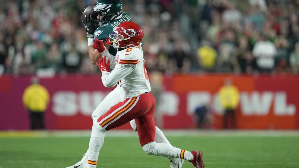 Philadelphia Eagles tight end Dallas Goedert (88) catches a pass while defended by Kansas City Chiefs safety Bryan Cook (6) during the second half of the NFL Super Bowl 57 football game, Sunday, Feb. 12, 2023, in Glendale, Ariz. (AP Photo/Abbie Parr)