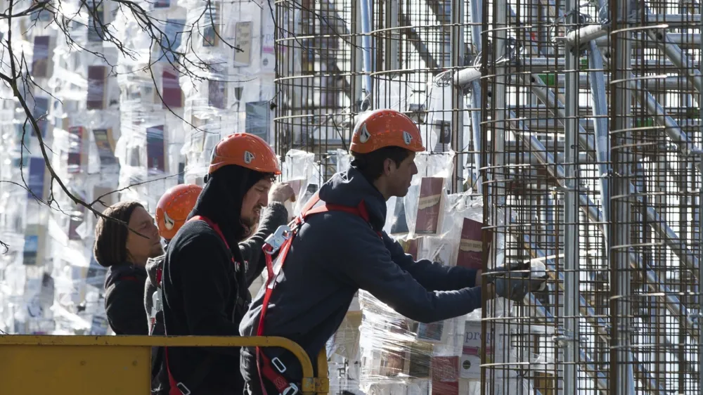 ﻿Workers hang books wrapped in plastic on the steel construction frame for the documenta art work "The Parthenon of Books' in Kassel, Germany, 24 April 2017. The reconstruction of the Parthenon temple of the Argentinian artist Marta Minujin is one of the largest projects of the Documenta. The Documenta will take place in Kassel from the 10th of June to the 17th of September 2017. Photo by: Swen Pf'rtner/picture-alliance/dpa/AP Images