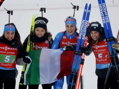 Biathlon - Biathlon World Championship - Oberhof, Germany - February 18, 2023 Italy's Samuela Comola, Dorothea Wierer, Hannah Auchentaller and Lisa Vittozzi celebrate after winning the women's 4x6km relay competition REUTERS/Lisa Leutner