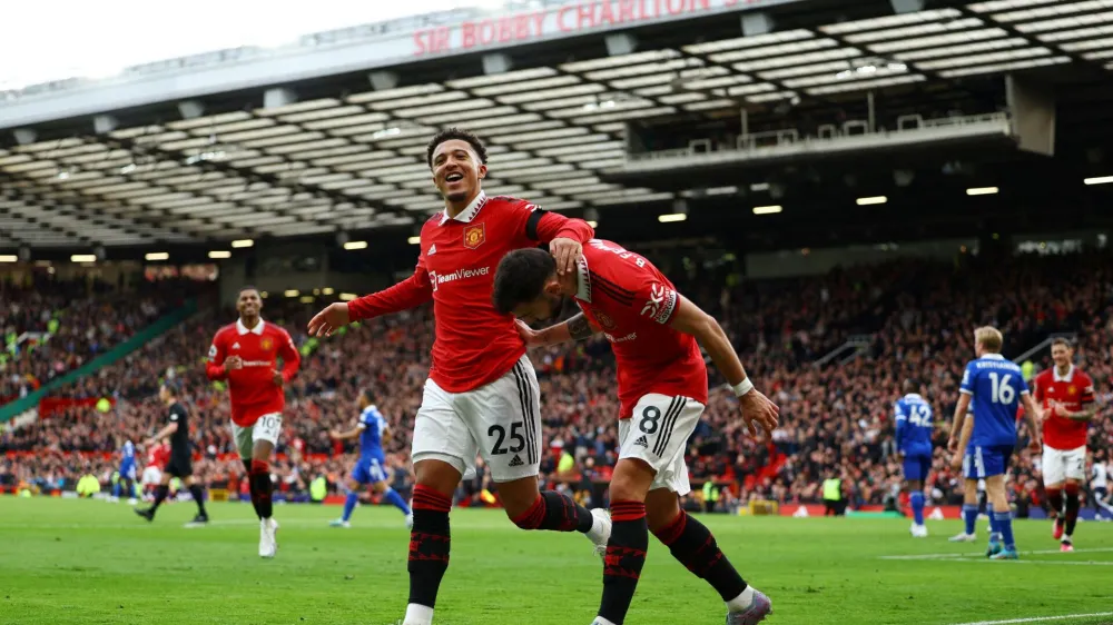 Soccer Football - Premier League - Manchester United v Leicester City - Old Trafford, Manchester, Britain - February 19, 2023 Manchester United's Jadon Sancho celebrates scoring their third goal with Bruno Fernandes REUTERS/Molly Darlington EDITORIAL USE ONLY. No use with unauthorized audio, video, data, fixture lists, club/league logos or 'live' services. Online in-match use limited to 75 images, no video emulation. No use in betting, games or single club /league/player publications. Please contact your account representative for further details.   TPX IMAGES OF THE DAY