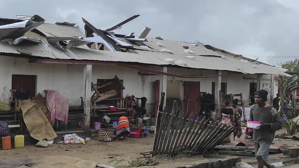 A man walks by damaged building, in Mananjary district, Madagascar, Wednesday Feb. 22, 2023 after cyclone Freddy reached Madagascar. A slightly weakened Cyclone Freddy has made landfall in Madagascar, where schools, businesses and public transportation were shut down ahead of its arrival. Freddy was packing winds gusting to 180 kilometers per hour, or about 111 miles per hour, as it came ashore in a nation already hit in January by a tropical storm that killed at least 30 people. (AP Photo/Solofo Rasolofomanana)