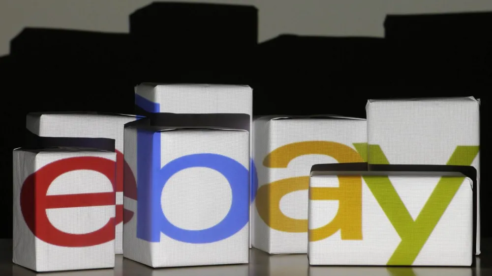 An eBay logo is projected onto white boxes in this illustration picture taken in Warsaw, January 21, 2014. eBay the world's second largest Internet retailer expected to post a 16% profit increase in its fourth quarter January 22, 2014. Picture taken January 21. REUTEwhite RS/Kacper Pempel (POLAND - Tags: BUSINESS)